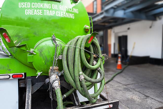 a service truck pumping grease from a restaurant's grease trap in Meriden